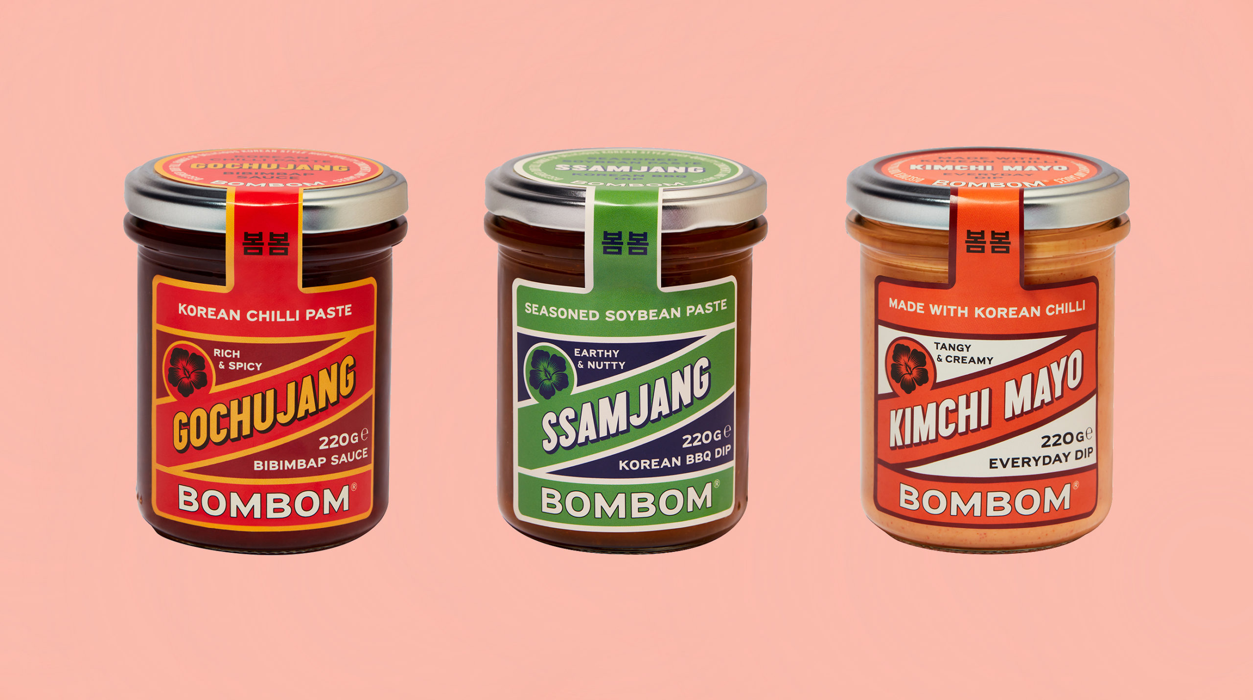 Three jars of Korean condiments by BomBom: Gochujang chilli paste, Ssamjang soybean paste, and Kimchi Mayo, arranged on a pink background.